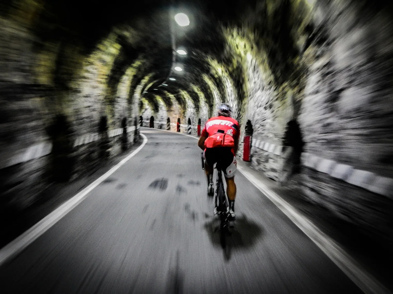 Riding through a tunnel during the Cent Cols Challenge