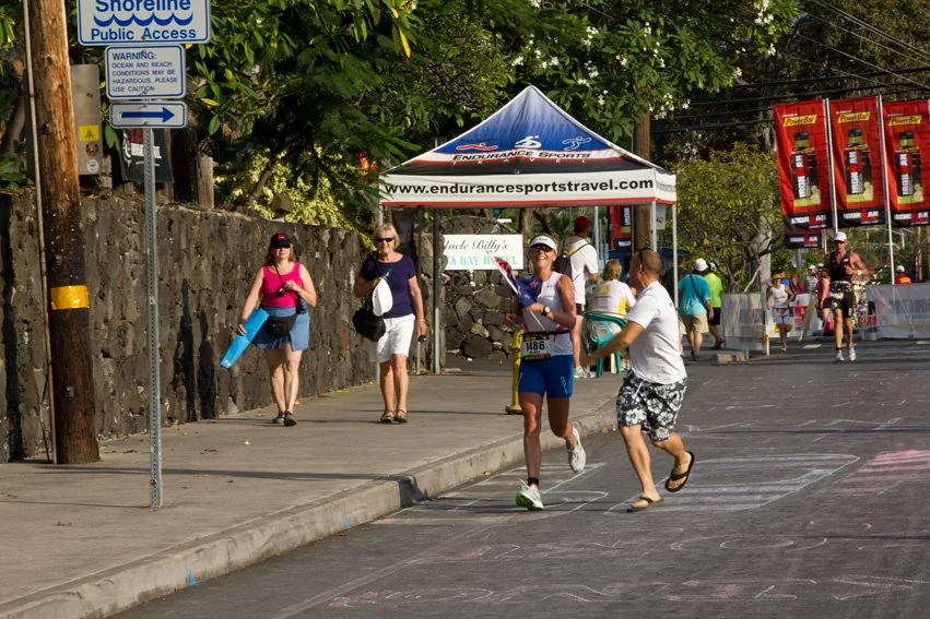Kristian running beside Belinda Harper on Ali'i Drive in flip-flops