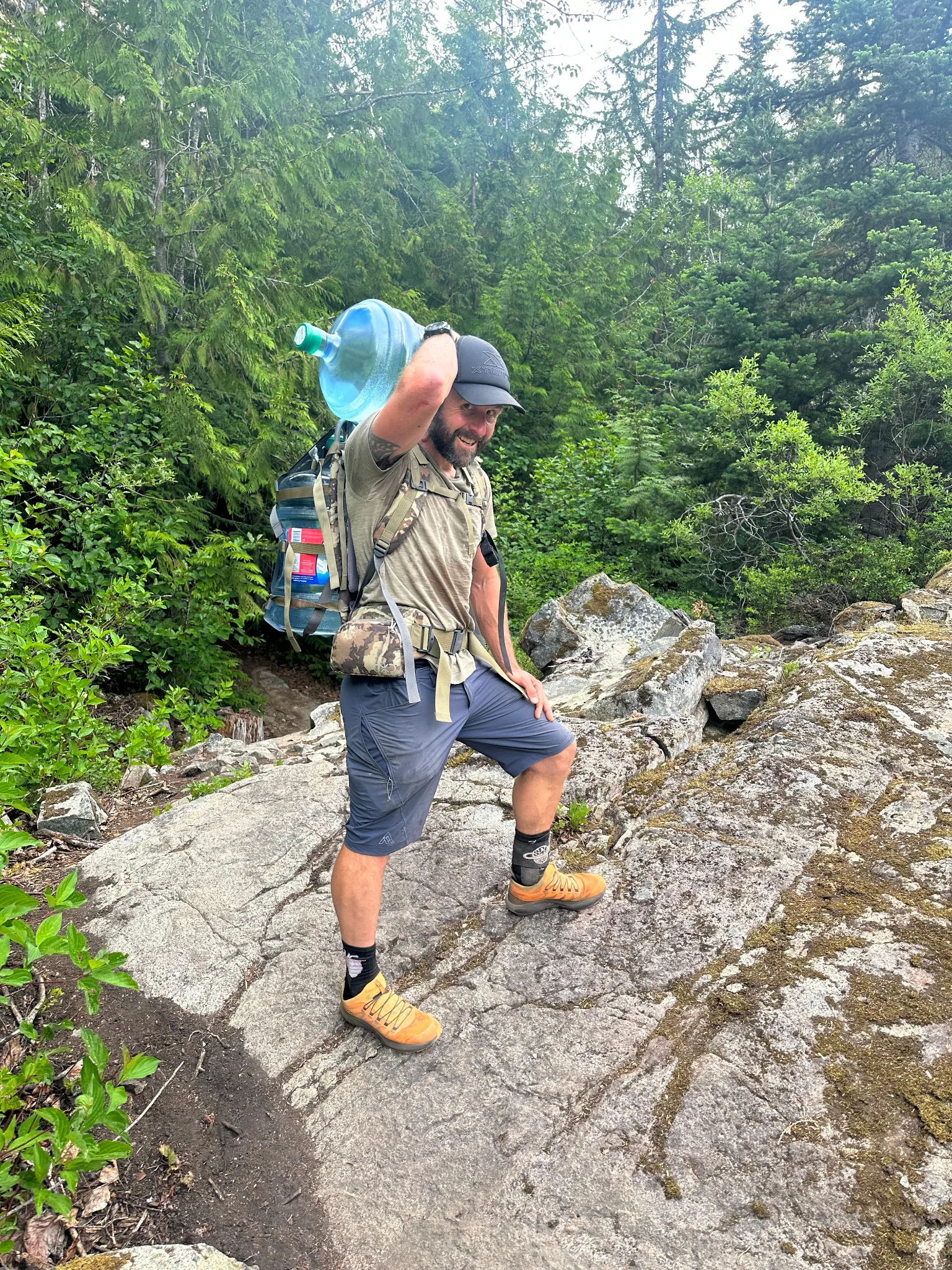 Kristian carrying water into a remote race aid station